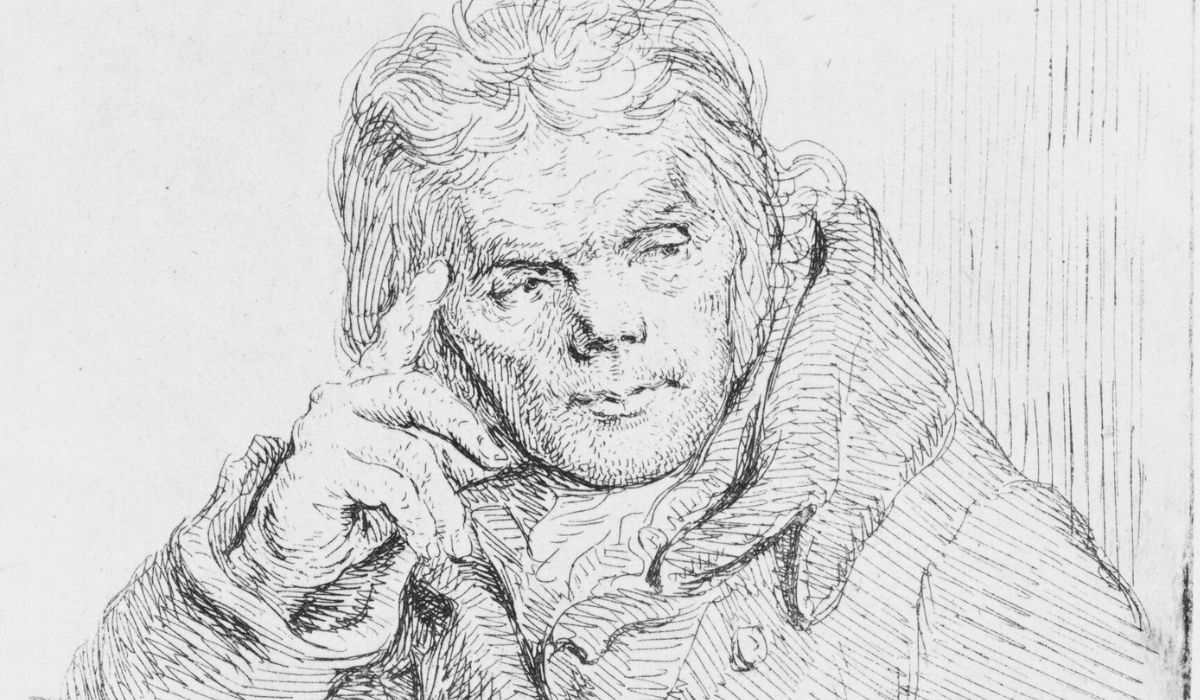 An old man in a fur coat sitting on a chair