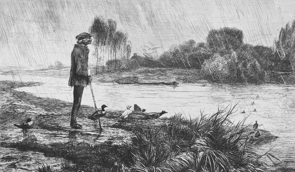 Old man stands near a river in the rain with ducks
